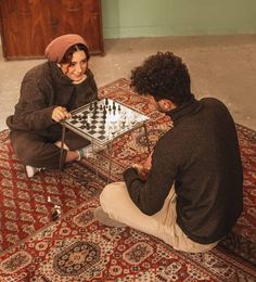 a man and woman playing chess on a rug with the caption, in arabic