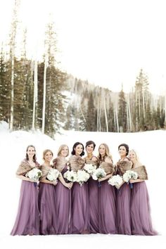 a group of women standing next to each other in the snow