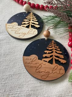 two wooden christmas ornament hanging from a tree