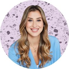 a woman with long hair smiling in front of a purple background and an animal print circle