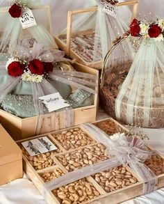 several baskets filled with nuts and flowers on top of a white cloth covered tablecloth