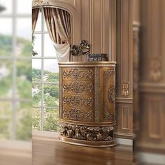 there is a gold cabinet in the corner of this room, and it looks very elegant