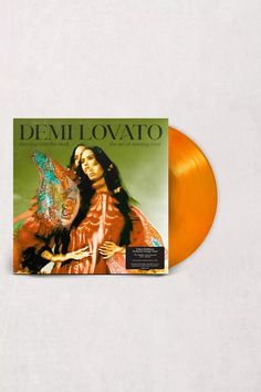 an orange vinyl record with the cover of demmovato on it's side