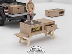 a man sitting on a stool next to a table with drawers in the shape of a truck