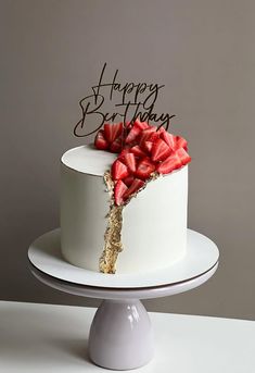 a birthday cake with strawberries on top