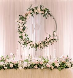 the table is covered with flowers and greenery