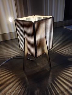 a wooden table sitting on top of a hard wood floor next to a curtained wall