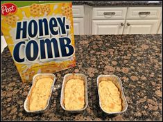 three tins of food sitting on top of a counter next to a box of honey comb