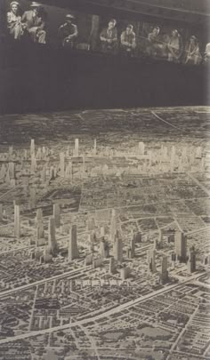 an aerial view of a city with lots of tall buildings and people in the sky