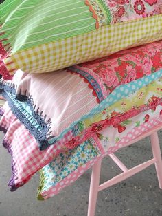 four different images of colorful pillows on a chair