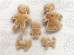 four gingerbread cutouts are shown on a table