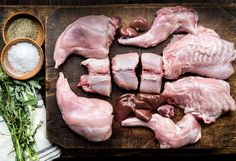 raw chicken on a cutting board with spices and seasoning