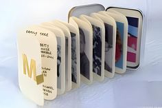 a set of four personalized photo frames in tins with magnets on them