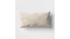 a white and beige pillow sitting on top of a wall