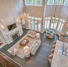 an aerial view of a living room with couches and chandeliers in it