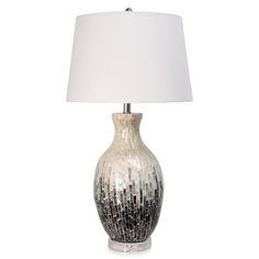 a silver and white vase lamp with a white shade