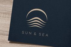 the sun and sea logo is displayed on a wooden surface