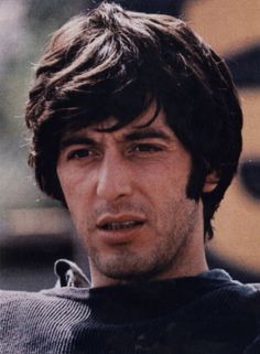 an old photo of a young man with dark hair and brown eyes looking at the camera