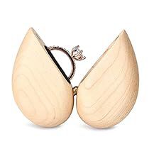 a wooden ring holder with two pears on it's sides, one in the shape of an egg