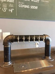 the pipes are lined up on the counter in front of the chalk board that says hotplate