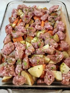 a glass dish filled with meat and potatoes