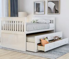 a white bunk bed with drawers underneath it and pictures on the wall behind it in a bedroom