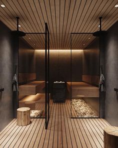 an indoor sauna with wooden floors and benches