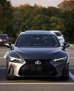 the front end of a black sports car in a parking lot