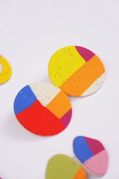 three colorful circles on a white surface next to each other