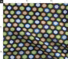 a close up view of a fabric with circles and dots in blue, green, brown and white