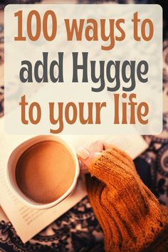 100 ways to add hygge to your life: woman's hand and arm in cozy sweater holding cup of tea beside an open book. Hygge Images, Hygge Kitchen, Danish Words, Cozy Things