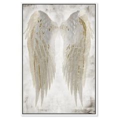 two white angel wings with gold foil paint on the back of them, against a gray background