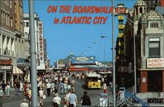 an old photo of people walking on the boardwalk in atlantic city