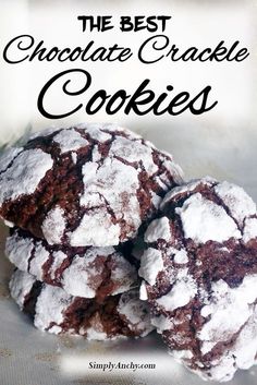 chocolate crinkle cookies with powdered sugar are piled on top of each other