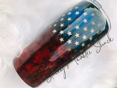 a red, white and blue glass tumbler with the american flag painted on it