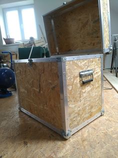 a large wooden box sitting on top of a hard wood floor