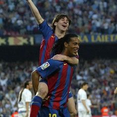 two soccer players are hugging each other on the field