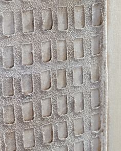 a close up view of a wall with small squares on it