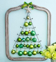 a christmas tree made out of ornaments in a frame