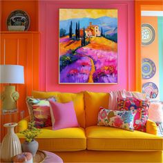 a living room filled with furniture and colorful paintings on the wall above it's couches