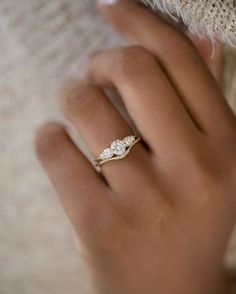 a woman's hand with a diamond ring on it