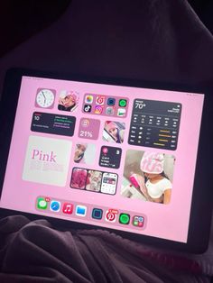 a person holding up a pink tablet with pictures on it's screen and buttons