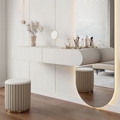 a large mirror sitting on top of a wooden floor next to a white table and stool