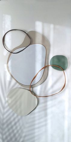 three circular mirrors sitting on top of a white table