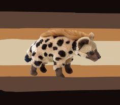 a stuffed animal that looks like a spotted hyena is standing in front of a striped background