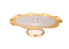 a white and gold plate on a stand