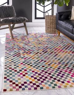 a living room area with a couch, chair and rug