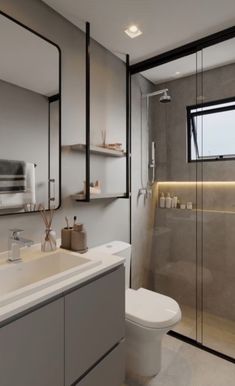 a bathroom with a toilet, sink and shower in it's own area next to a walk - in shower