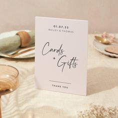 a card that says cards and gifts sitting on top of a table next to plates