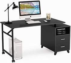 a computer desk with a monitor, keyboard and mouse on it in front of a white background